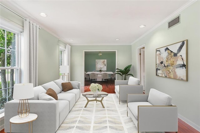 living room with light hardwood / wood-style flooring and ornamental molding