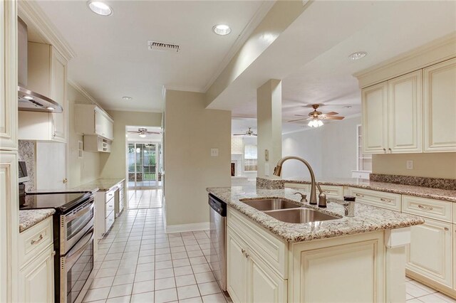 kitchen featuring ceiling fan, appliances with stainless steel finishes, cream cabinetry, and sink