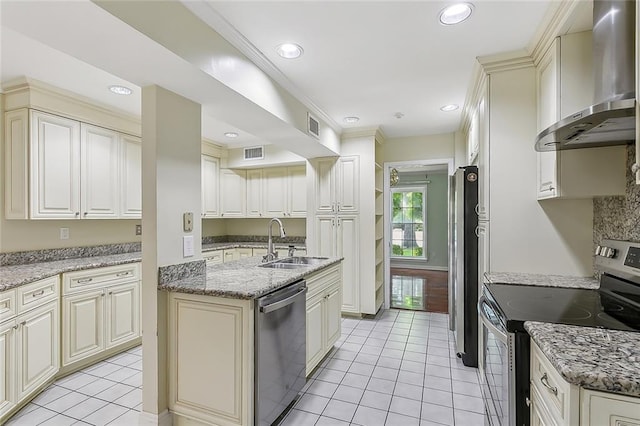 kitchen featuring light stone counters, light tile patterned floors, sink, wall chimney exhaust hood, and appliances with stainless steel finishes