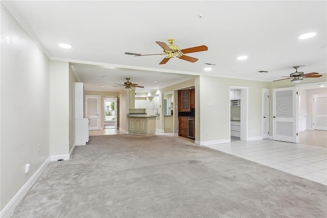 unfurnished living room featuring crown molding, light carpet, and ceiling fan