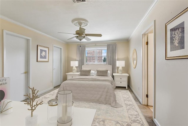 bedroom with ceiling fan and crown molding