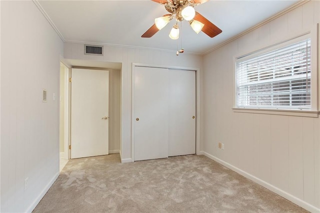 unfurnished bedroom with crown molding, ceiling fan, and light colored carpet