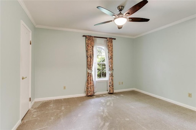 carpeted spare room with ornamental molding and ceiling fan