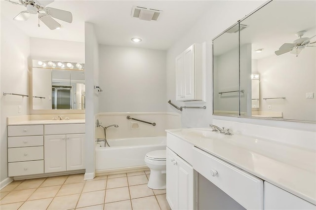 bathroom with a bathing tub, vanity, tile patterned flooring, ceiling fan, and toilet