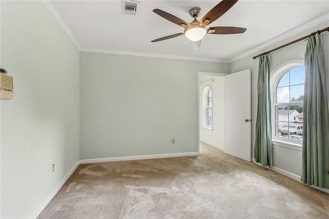 spare room with ornamental molding, light carpet, and ceiling fan