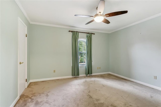 spare room with ornamental molding, ceiling fan, and light colored carpet