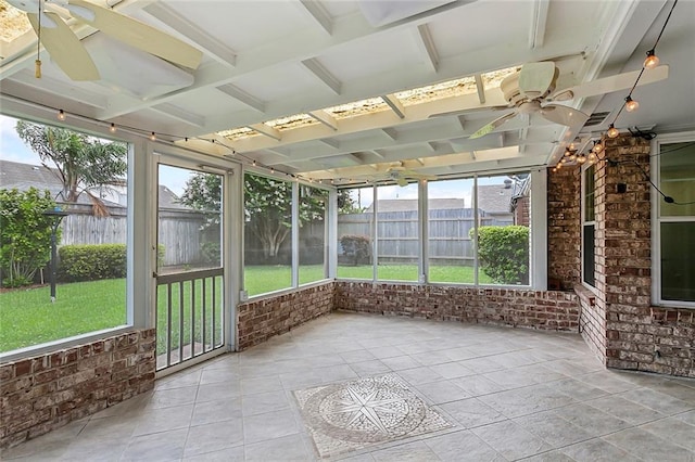 unfurnished sunroom with ceiling fan and a wealth of natural light