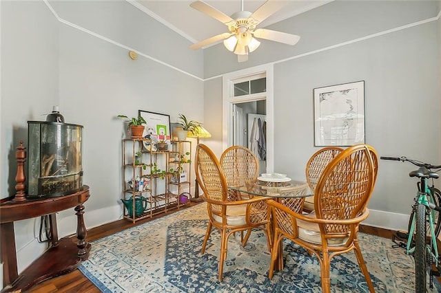 dining area featuring crown molding, wood finished floors, baseboards, and ceiling fan