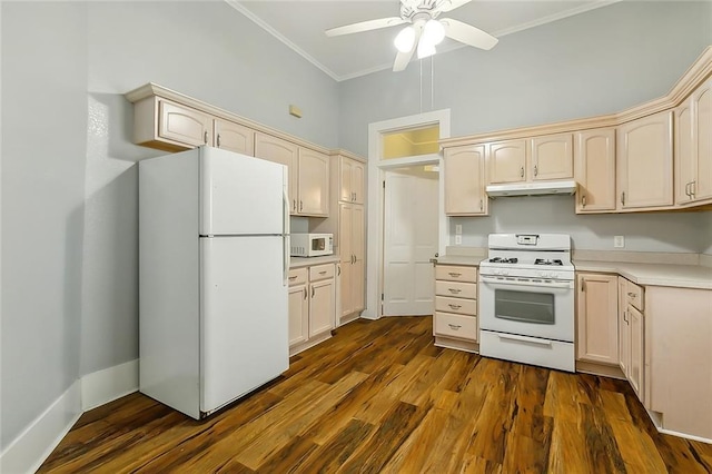 kitchen featuring dark wood-type flooring, ornamental molding, under cabinet range hood, white appliances, and light countertops