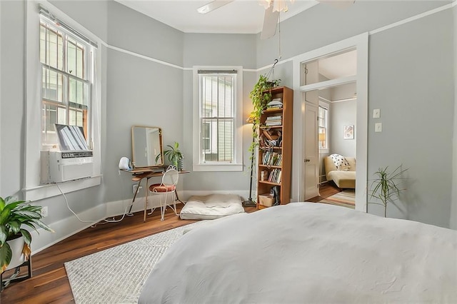 bedroom with ceiling fan, baseboards, and wood finished floors