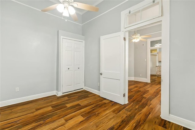 unfurnished bedroom with baseboards, wood finished floors, and a ceiling fan