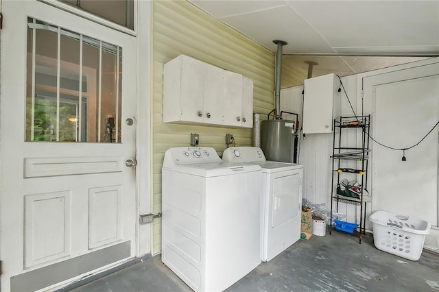 laundry area with gas water heater, cabinet space, and separate washer and dryer