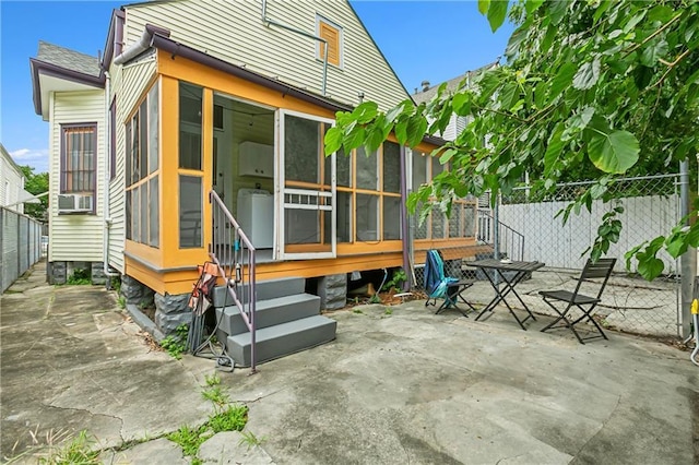 exterior space with a patio area, fence, and a sunroom