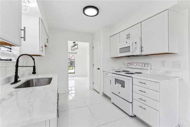 kitchen featuring sink, light tile patterned floors, light stone counters, white appliances, and white cabinets