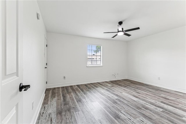 spare room featuring hardwood / wood-style floors and ceiling fan