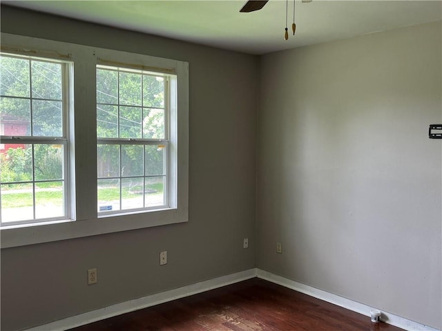 empty room featuring dark hardwood / wood-style flooring and ceiling fan