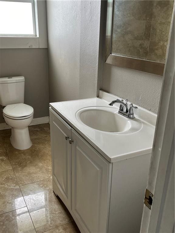 bathroom featuring tile patterned floors, vanity, and toilet