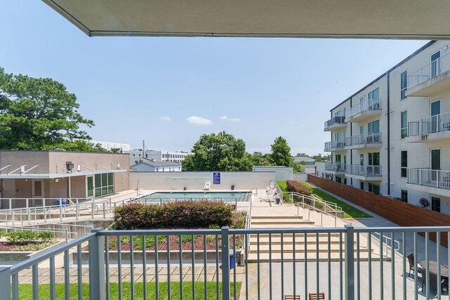 balcony featuring a community pool