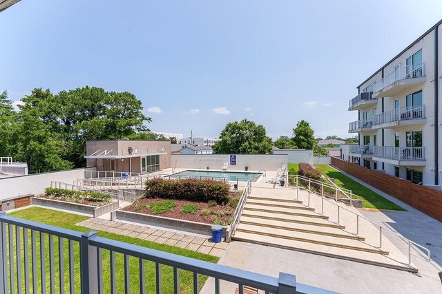 view of home's community with a yard and a swimming pool