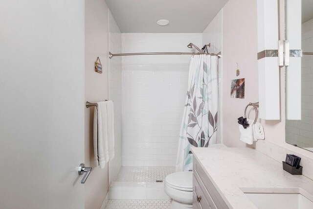 bathroom with tile patterned flooring, a shower with curtain, toilet, and vanity