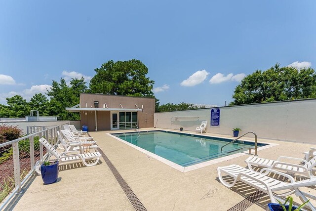 view of swimming pool with a patio