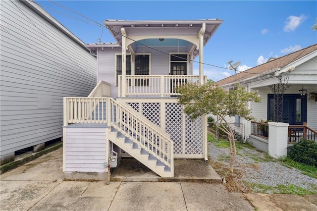 rear view of property with covered porch