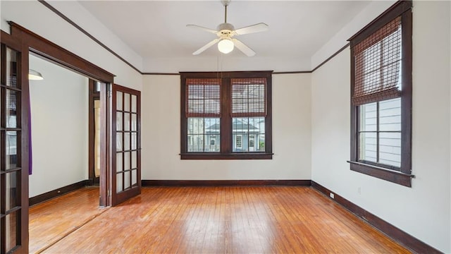 unfurnished room featuring french doors, ornamental molding, ceiling fan, and light hardwood / wood-style flooring