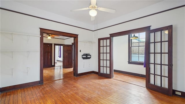 unfurnished room featuring french doors, ceiling fan, and hardwood / wood-style floors