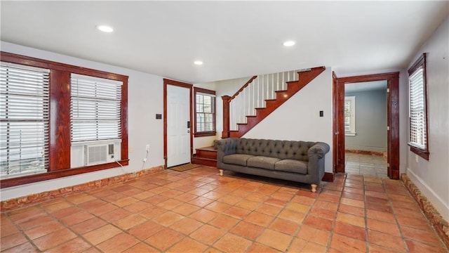 unfurnished living room featuring cooling unit and light tile patterned floors