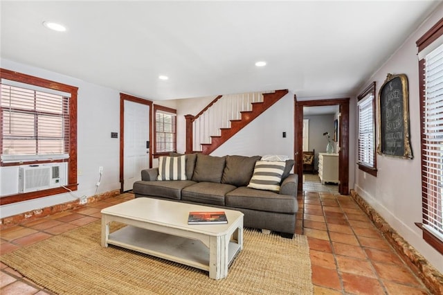 living room featuring a wealth of natural light and cooling unit