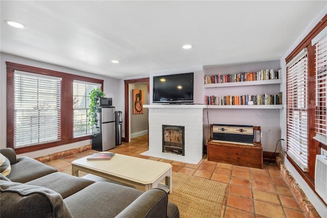 living room featuring light tile patterned flooring and a fireplace