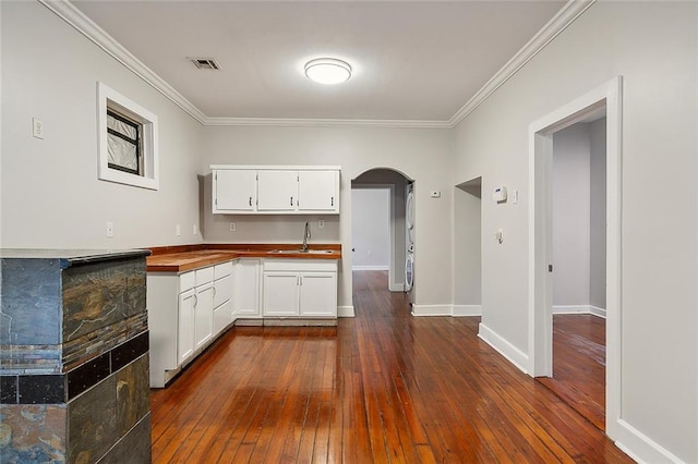 kitchen with sink, dark hardwood / wood-style flooring, and crown molding