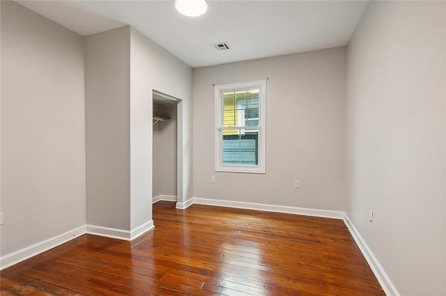 unfurnished bedroom featuring a closet and wood-type flooring