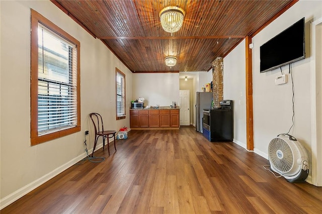 interior space with dark wood-type flooring, stainless steel refrigerator, and wood ceiling