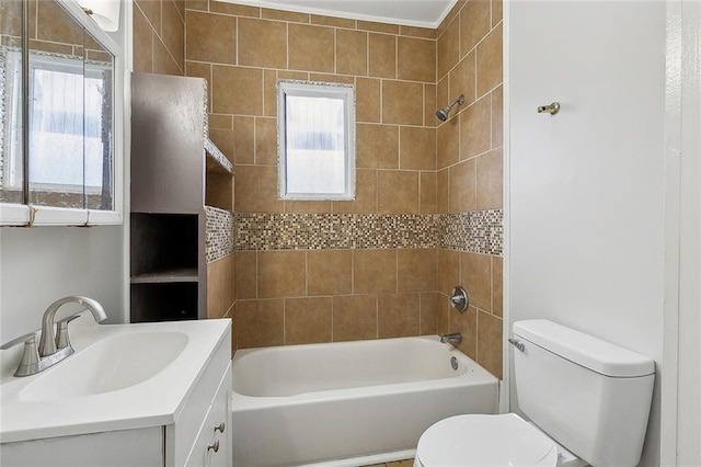 full bathroom featuring tiled shower / bath combo, vanity, and toilet