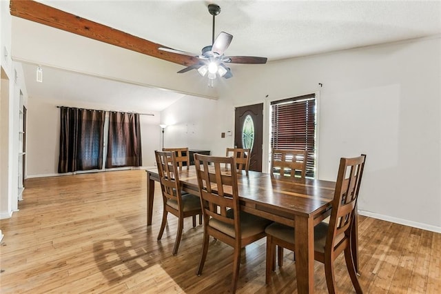 dining room with light wood-type flooring, lofted ceiling, and ceiling fan