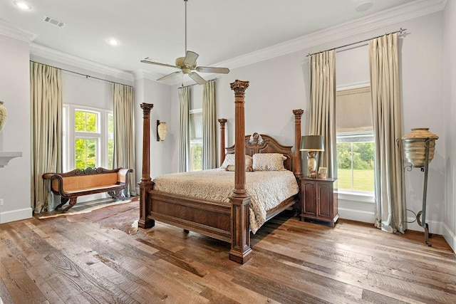 bedroom with ceiling fan, crown molding, and multiple windows