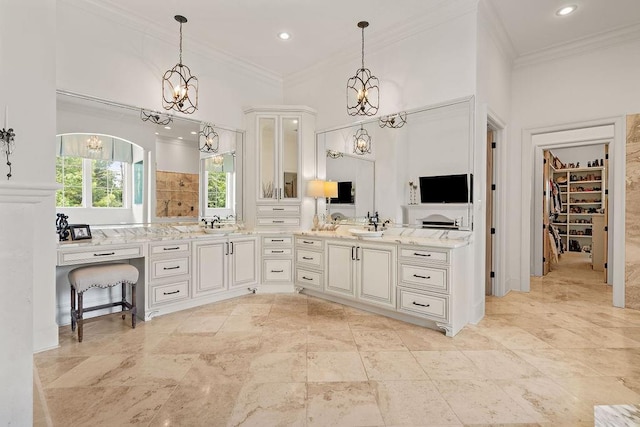 bathroom with vanity, a high ceiling, and ornamental molding