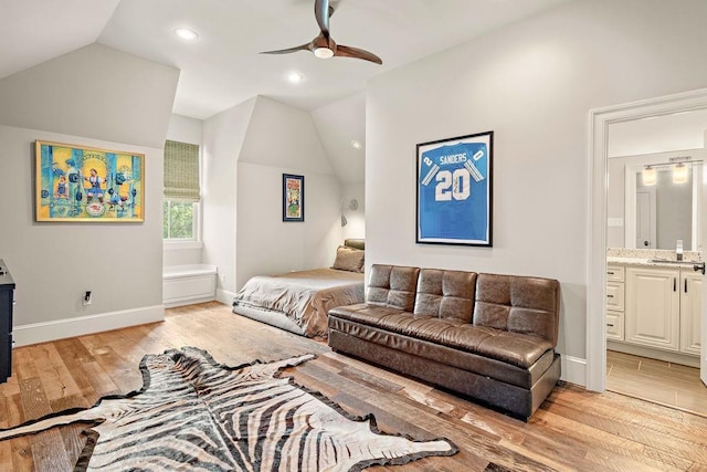 bedroom featuring ensuite bathroom, light hardwood / wood-style flooring, ceiling fan, and lofted ceiling