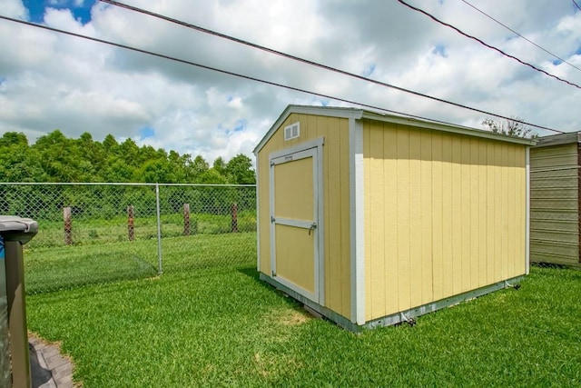 view of shed featuring fence