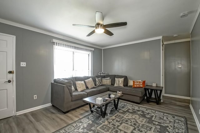 living room with ceiling fan, baseboards, wood finished floors, and crown molding