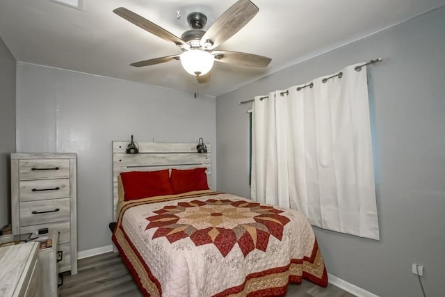 bedroom with baseboards, wood finished floors, and a ceiling fan