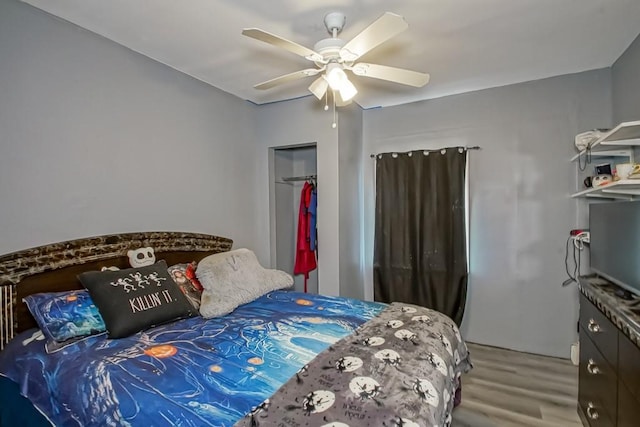 bedroom featuring ceiling fan and wood finished floors