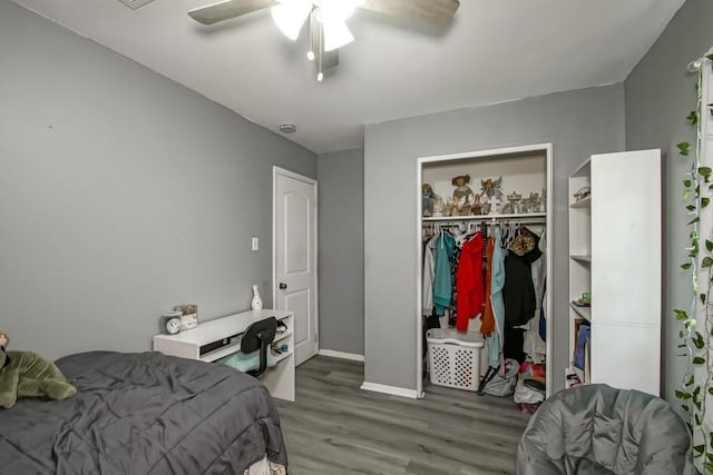 bedroom featuring a closet, baseboards, a ceiling fan, and wood finished floors