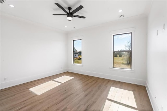 empty room featuring light hardwood / wood-style flooring, ceiling fan, and plenty of natural light