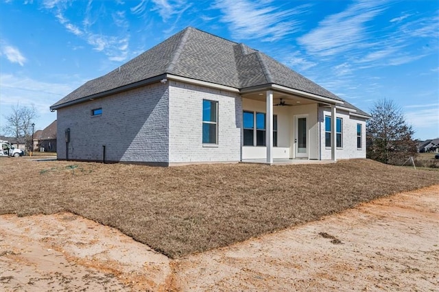 rear view of property with ceiling fan