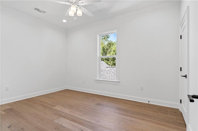 empty room with ceiling fan, ornamental molding, and light hardwood / wood-style floors