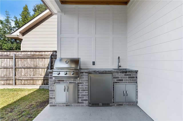 view of terrace with sink, exterior kitchen, and grilling area