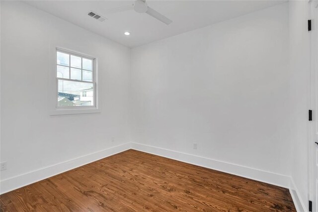 spare room with ceiling fan and hardwood / wood-style flooring