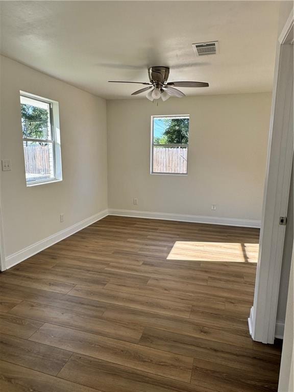 spare room featuring ceiling fan and dark hardwood / wood-style flooring